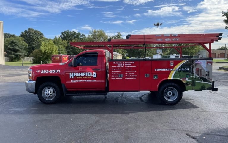Red Highfield Door Sales service truck with ladder rack